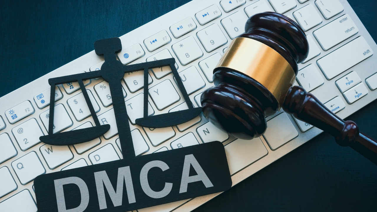 DMCA logo and gavel sitting on a computer keyboard